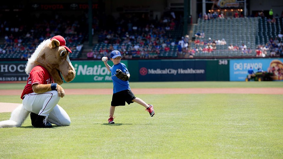 adopted child through buckner international throws first pitch at texas rangers game