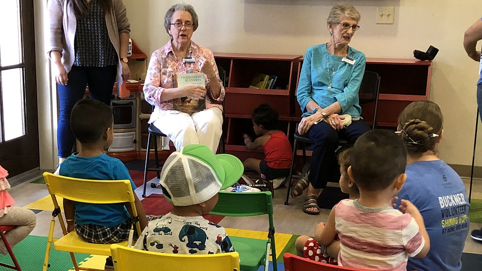buckner westminster place member reads to children