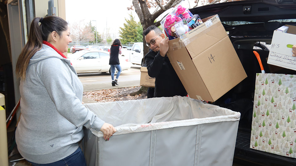 city credit union delivers toys to buckner