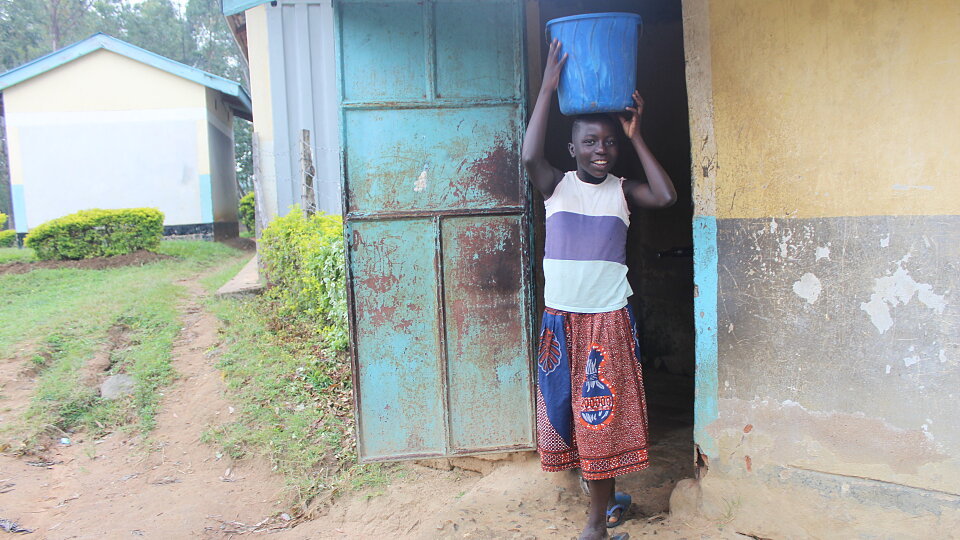 cynthia carrying water from the pump
