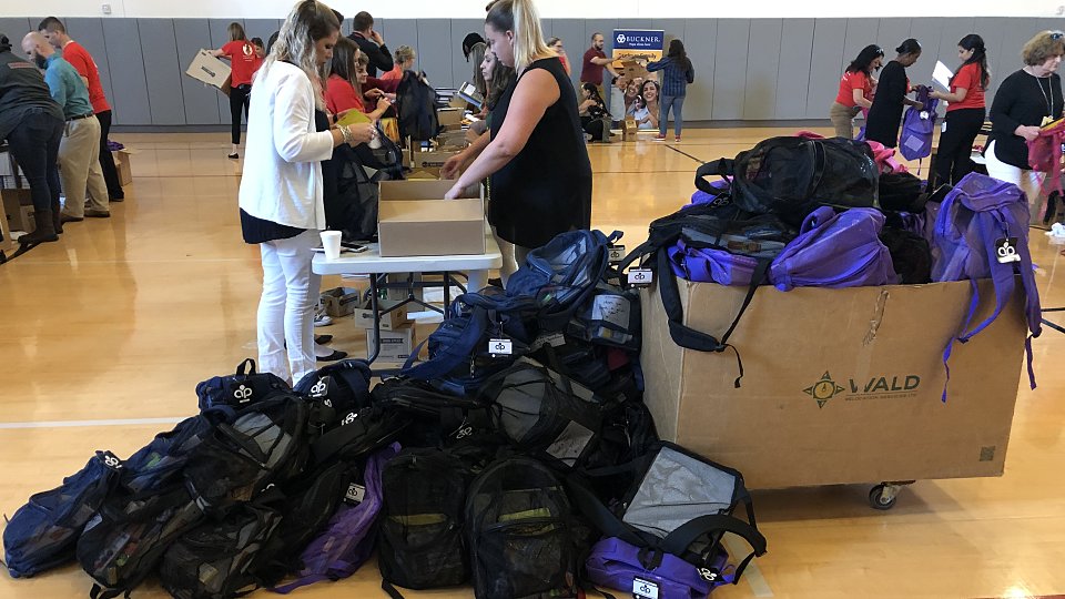 halliburton employees filled backpacks to give to children served by buckner