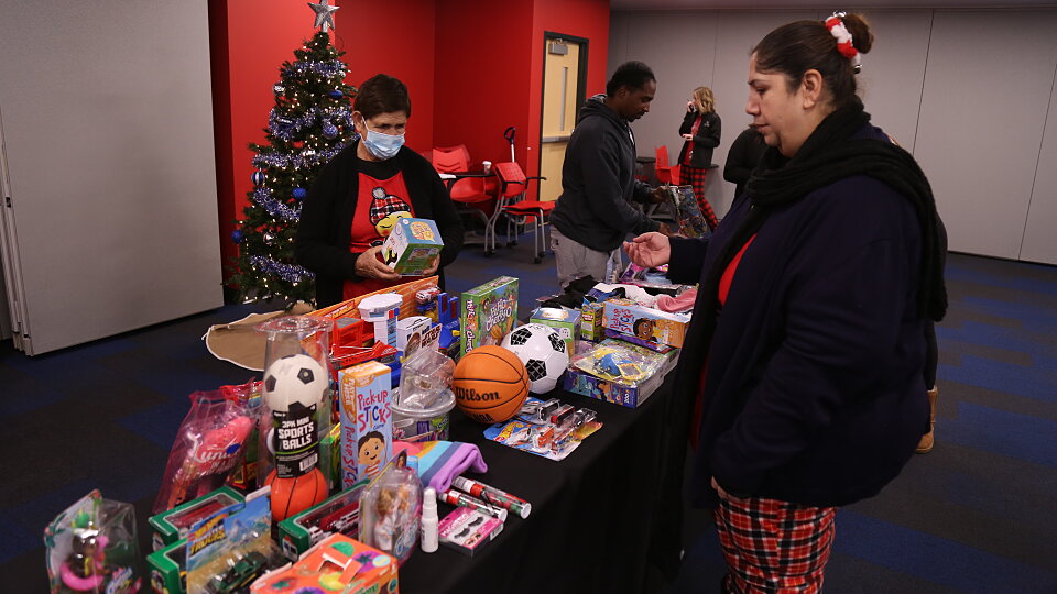 families shop for toys at the buckner christmas market in dallas