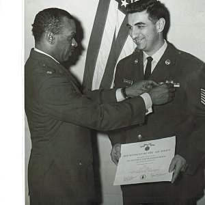 Col. Sam Lynn presenting DeMartino with his first Commendation Medal in 1965.