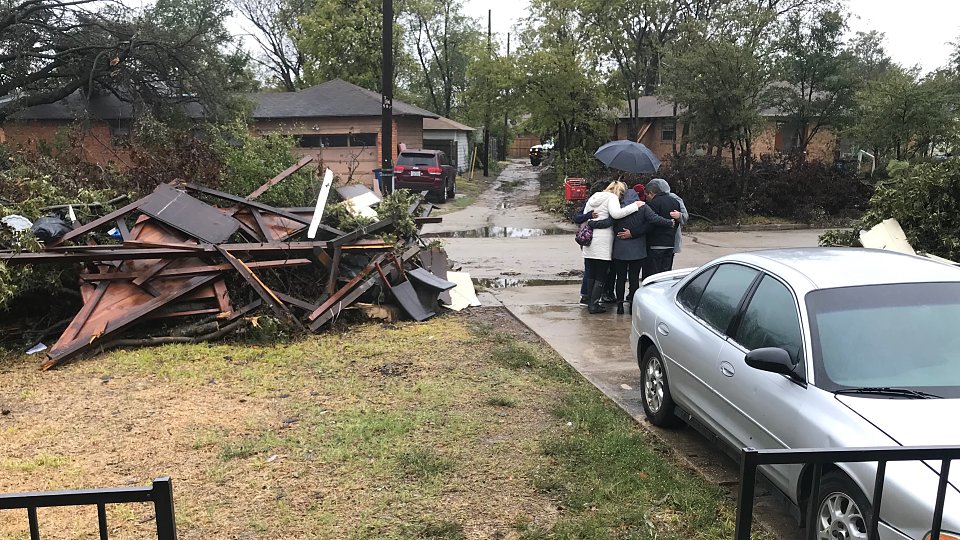 staff from buckner and communities foundation of texas pray for tornado victims