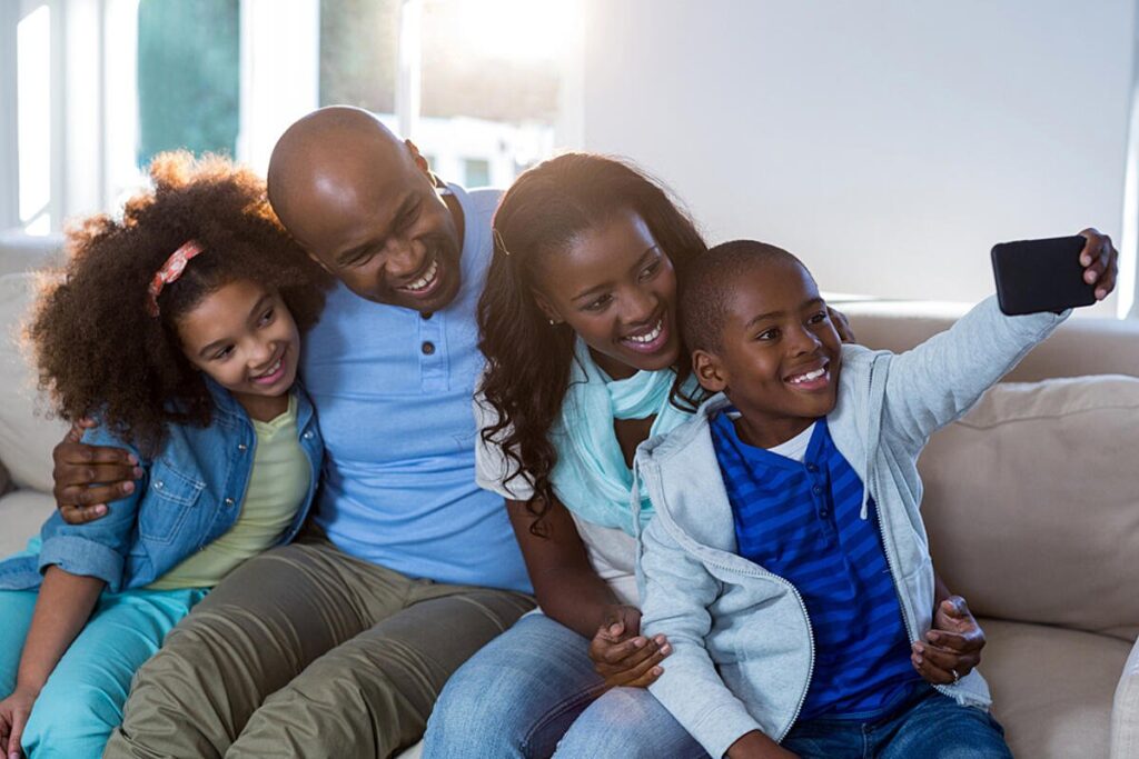 family-taking-selfie-from-mobile-phone-at-home