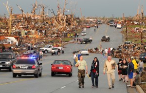 JOPLIN TORNADO - Residents of Joplin, Mo, walk west on 26th Street near Maiden Lane after a tornado hit the southwest Missouri city on Sunday evening, May 22, 2011. The tornado tore a path a mile wide and four miles long destroying homes and businesses.(AP/Mike Gullett)