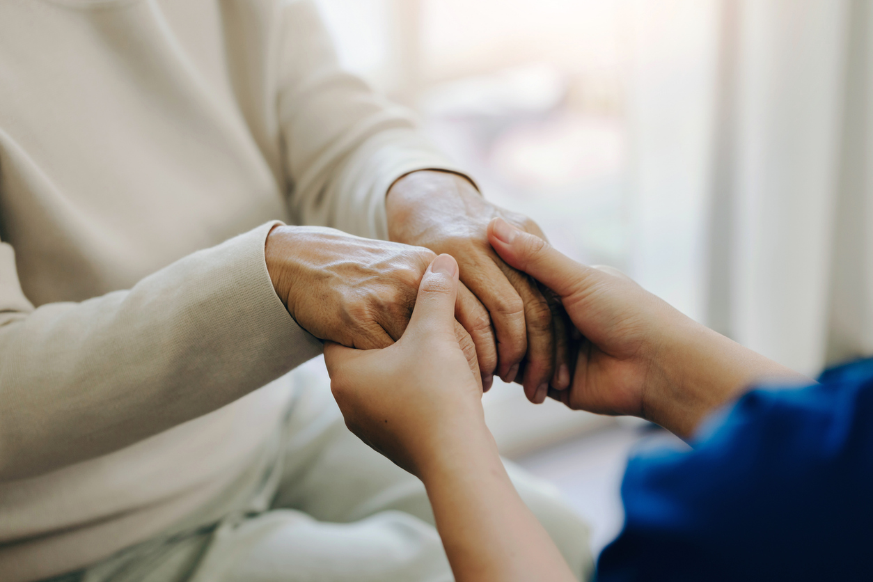 Female nurse holding her senior patient's hand. Giving Support. Female carer holding hands of senior woman. holding hands with patients with love, care, help, encouragement, and empathy. healthcare.