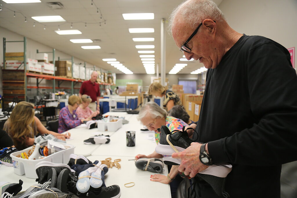 Seniors sort shoes for vulnerable children